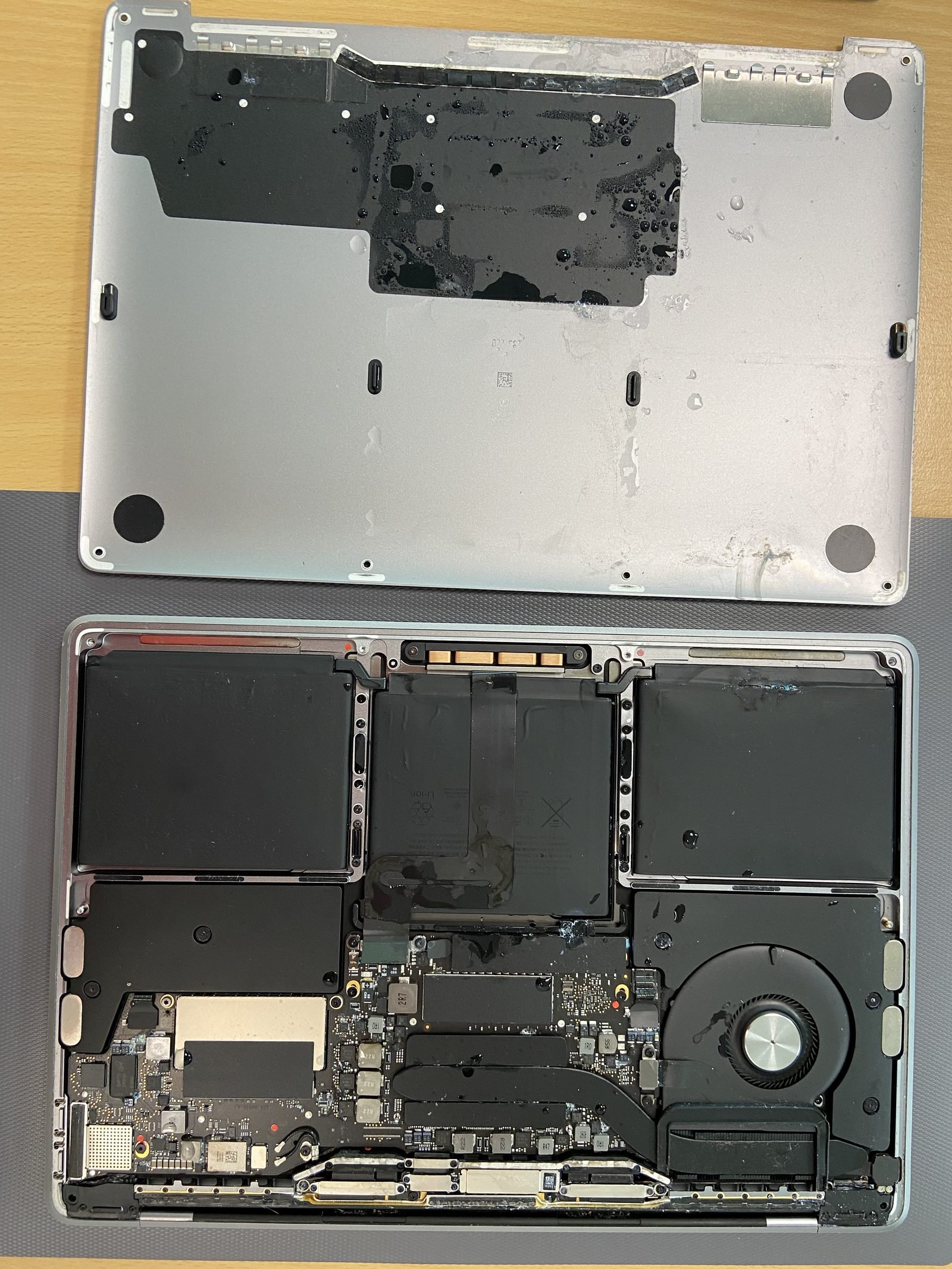 Water-damage internal repair MacBook bottom case removed showing the full internals during a water-damage repair in Dubai